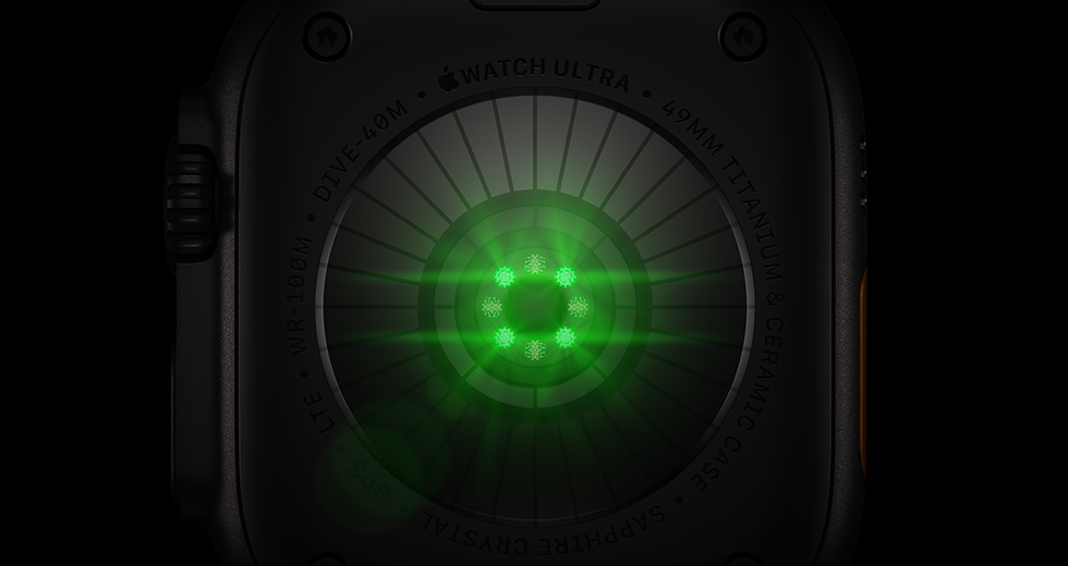 Back of Apple Watch Ultra 4, titanium case, black color, multiple round sensors with glowing green LED lights